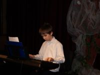 chłopiec grający na keyboardzie.